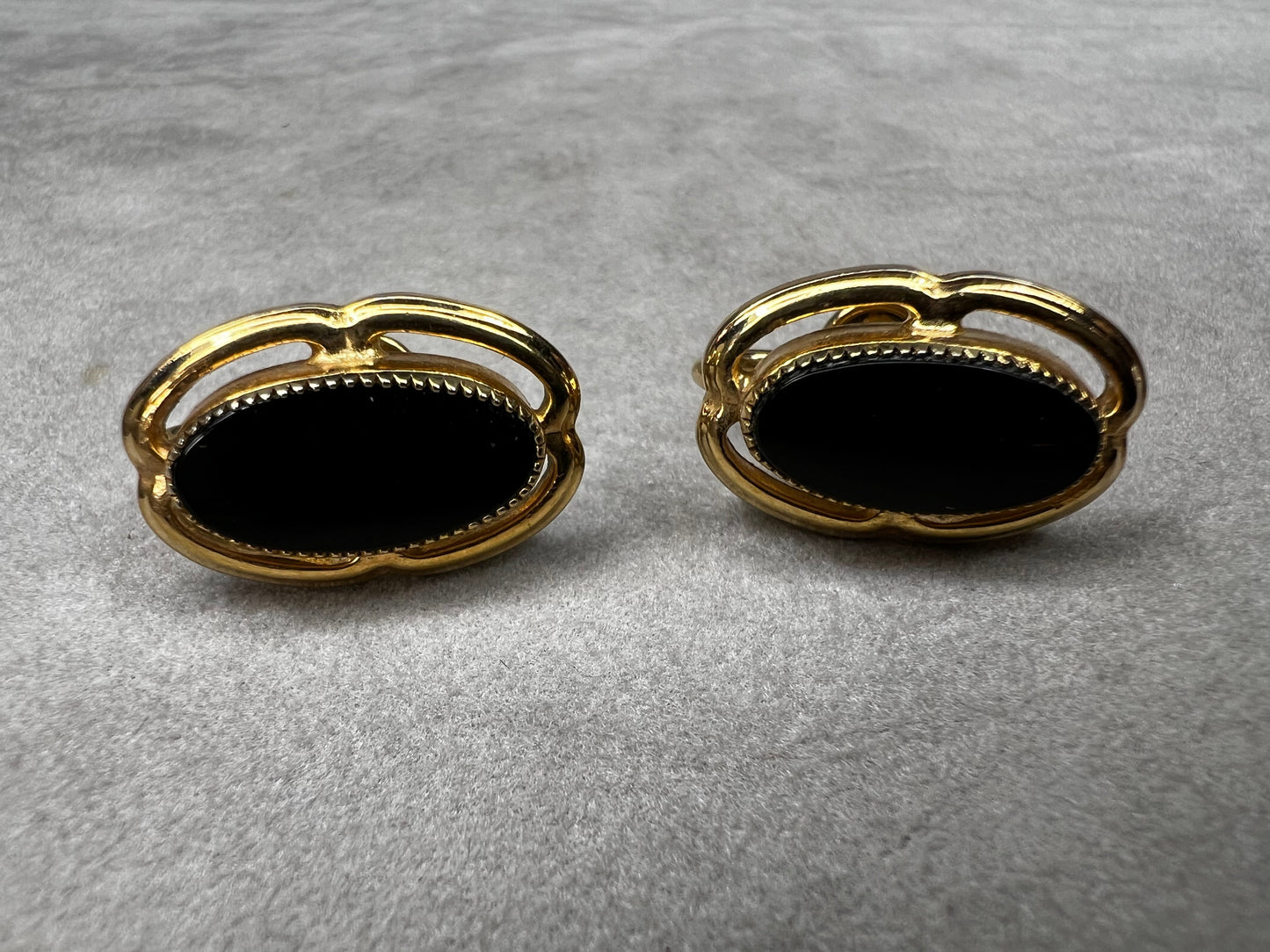 These screw-back earrings feature a beautiful oval piece of jet set in a stylish gold-filled frame.