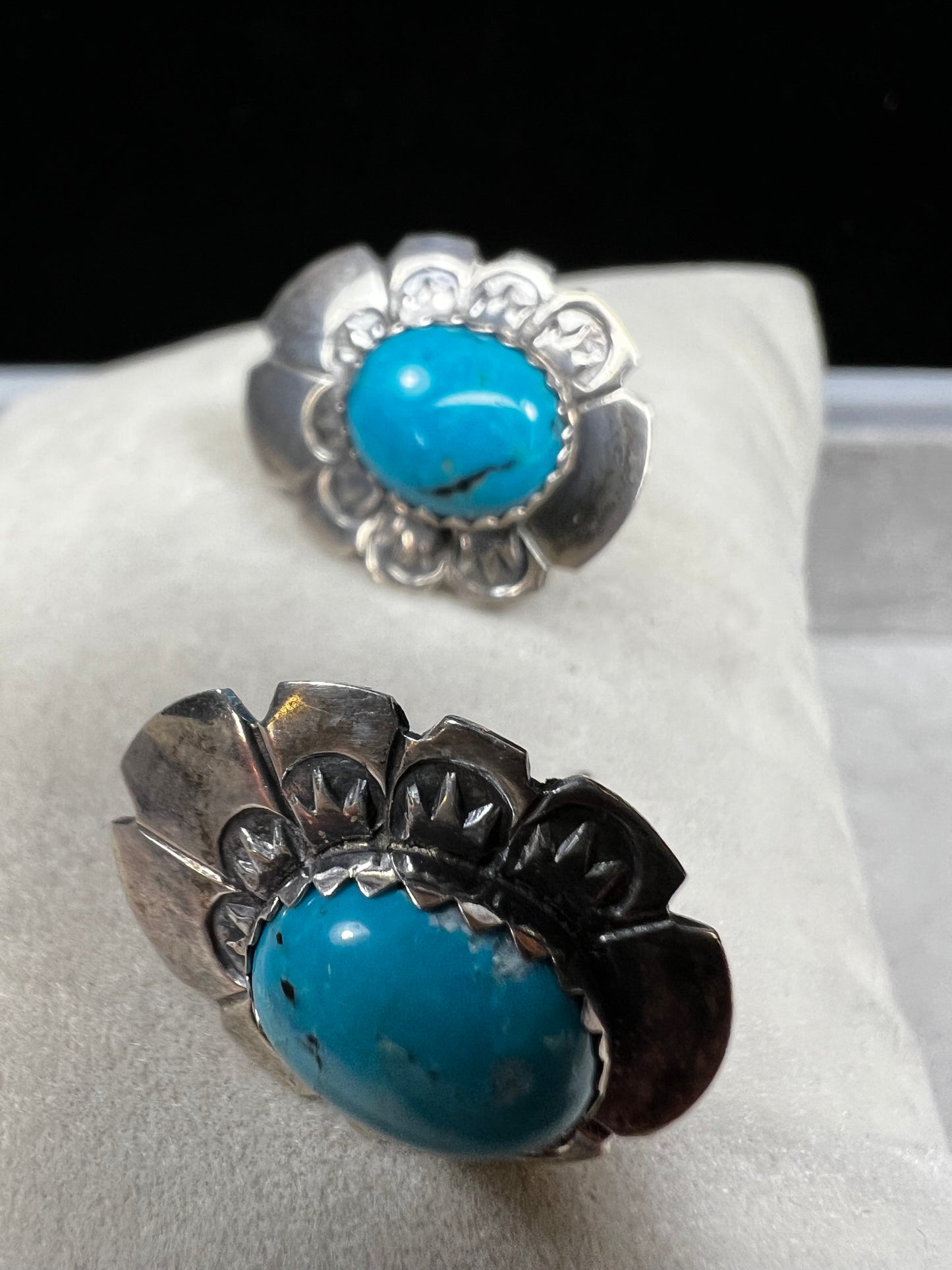 These sterling silver earrings showcase expertly crafted faux turquoise stones, set within intricately detailed silver settings. Signed LS.