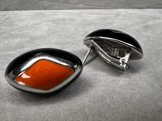 Add a vibrant touch to your collection with these vintage Italian earrings. Crafted from sterling silver, they feature striking orange and black inlay.