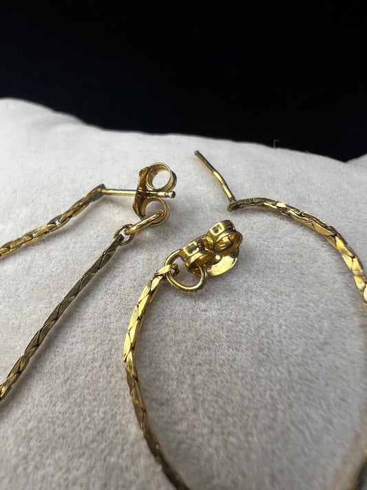 Crafted from 14k gold filled metal, these chain loop earrings feature permanently attached backs for a secure fit. The post passes through the ear, and the back loops around to close, combining elegant design with reliable functionality.