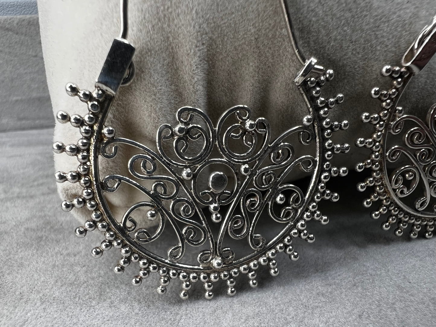 These sterling silver earrings offer a distinctive design that balances boldness with subtlety. Their intricate detailing adds sophistication without overwhelming your look.