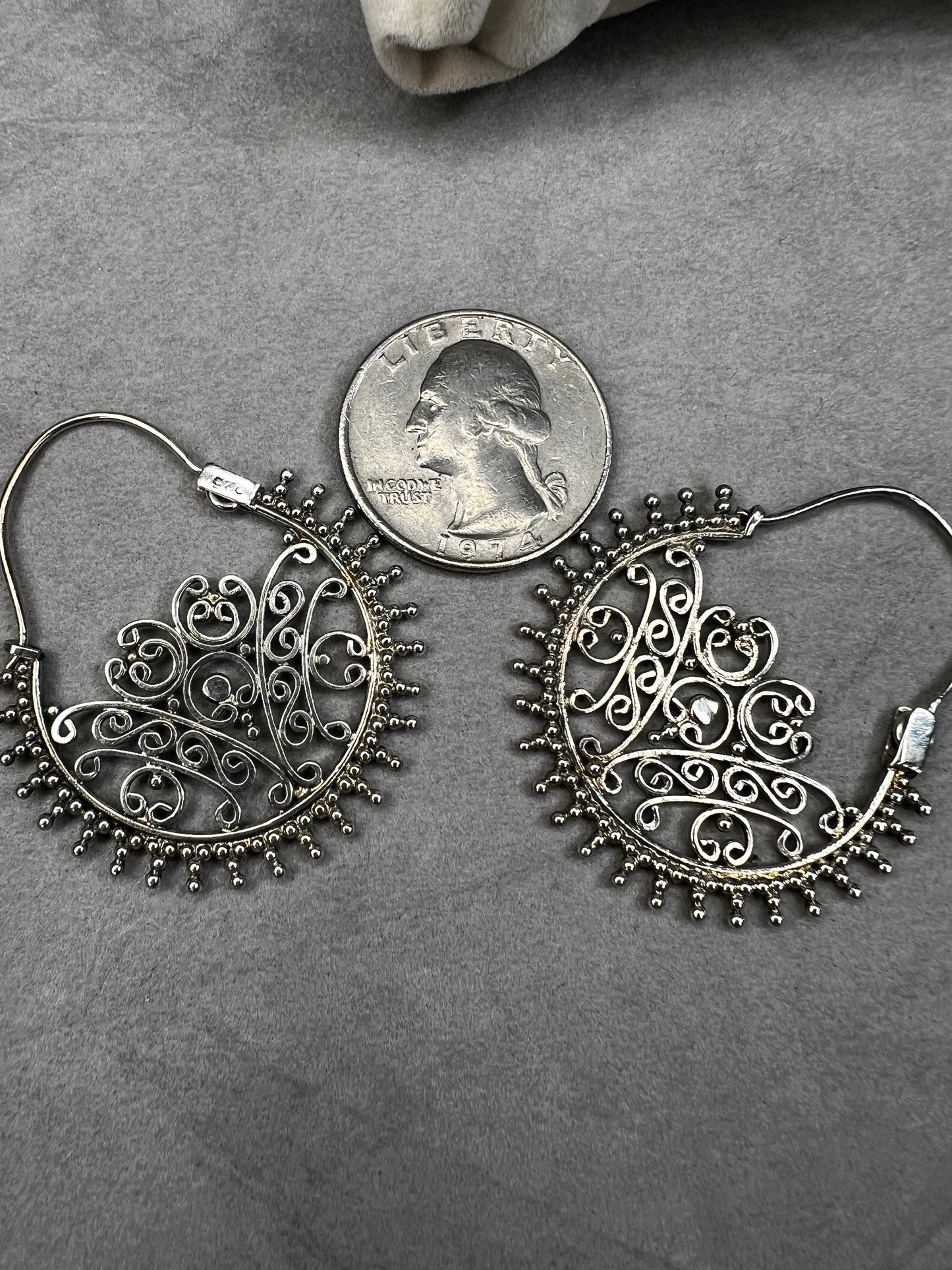 These sterling silver earrings offer a distinctive design that balances boldness with subtlety. Their intricate detailing adds sophistication without overwhelming your look.
