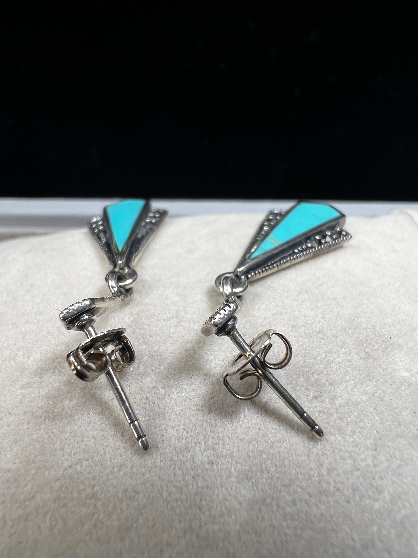 These sterling silver dangle earrings combine the timeless elegance of marcasite with the vibrant appeal of faux turquoise. They are an ideal accessory for adding vintage-inspired sophistication to any outfit.