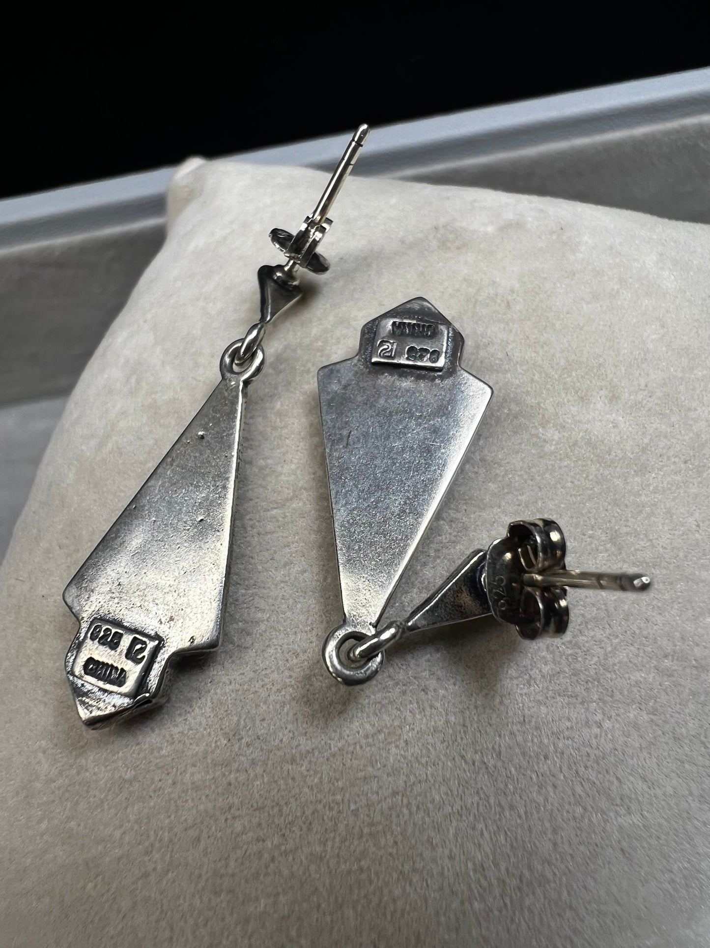 These sterling silver dangle earrings combine the timeless elegance of marcasite with the vibrant appeal of faux turquoise. They are an ideal accessory for adding vintage-inspired sophistication to any outfit.