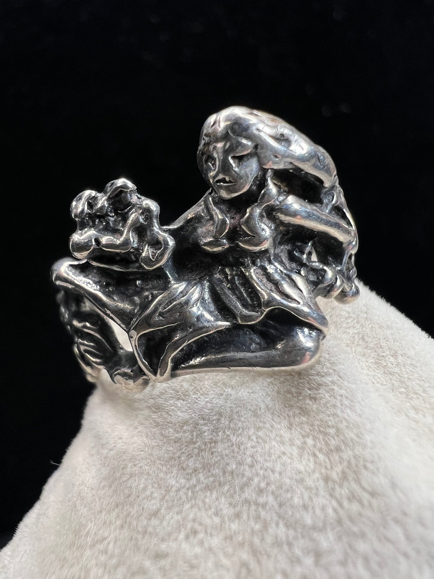 This sterling silver "lady in a dress" ring showcases expert craftsmanship with its solid construction. Its refined design captures a timeless aesthetic, making it a sophisticated addition to any jewelry collection. Perfect for those who appreciate quality and artistry in their accessories.