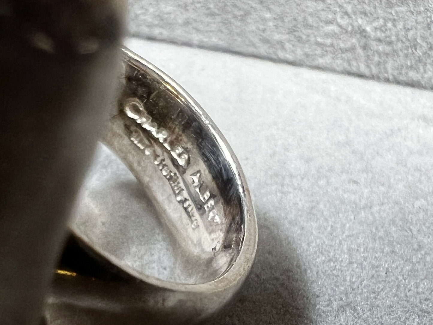 This sterling silver ring by Charles Albert showcases a striking 1 1/4" citrine specimen, combining expert craftsmanship with bold design. The large citrine centerpiece offers vibrant color and natural beauty, making it a distinctive accessory that will elevate any ensemble with refined elegance.