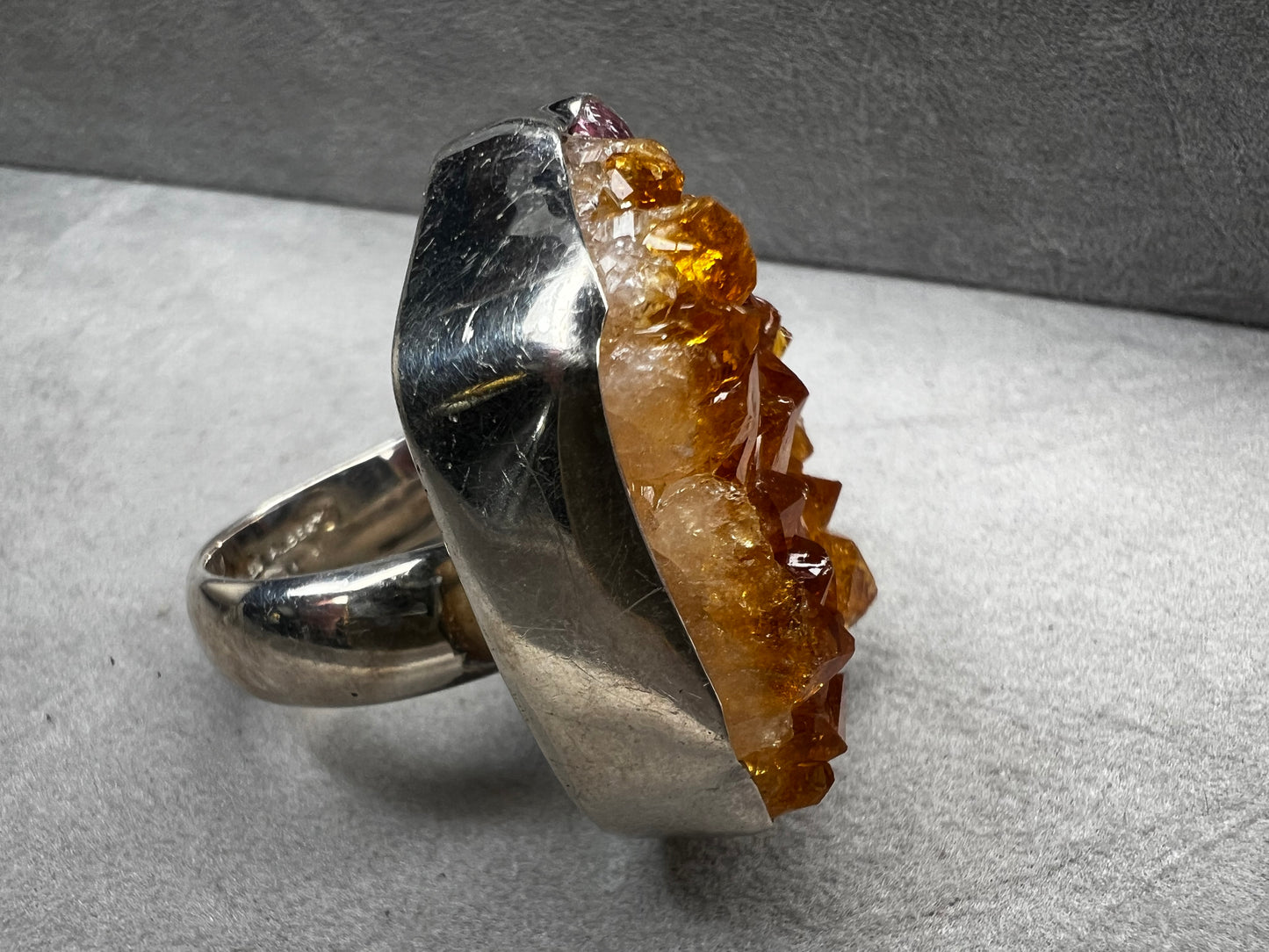 This sterling silver ring by Charles Albert showcases a striking 1 1/4" citrine specimen, combining expert craftsmanship with bold design. The large citrine centerpiece offers vibrant color and natural beauty, making it a distinctive accessory that will elevate any ensemble with refined elegance.