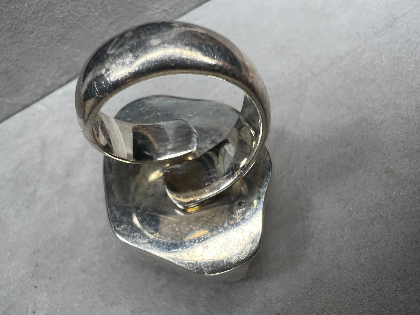 This sterling silver ring by Charles Albert showcases a striking 1 1/4" citrine specimen, combining expert craftsmanship with bold design. The large citrine centerpiece offers vibrant color and natural beauty, making it a distinctive accessory that will elevate any ensemble with refined elegance.