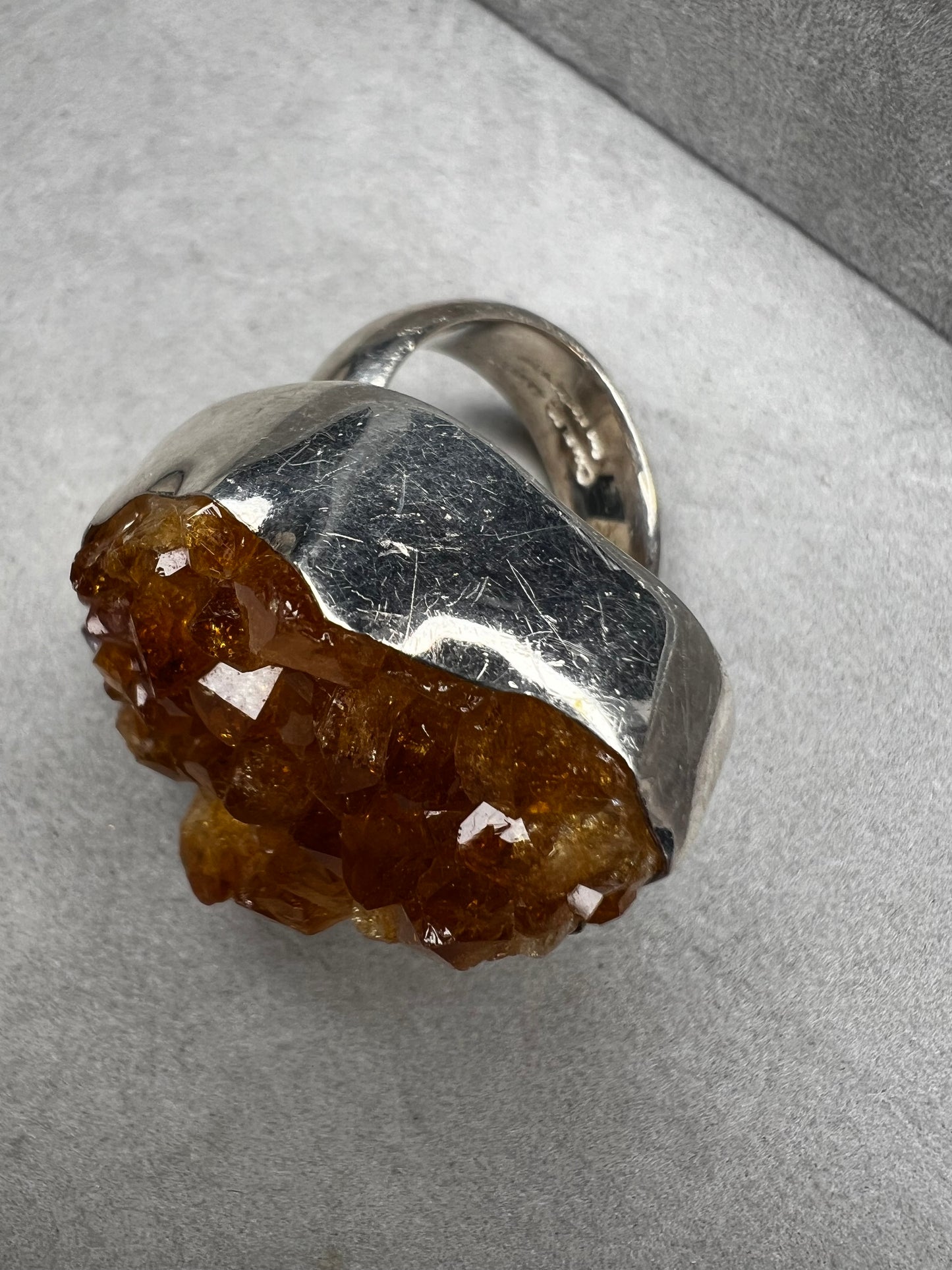 This sterling silver ring by Charles Albert showcases a striking 1 1/4" citrine specimen, combining expert craftsmanship with bold design. The large citrine centerpiece offers vibrant color and natural beauty, making it a distinctive accessory that will elevate any ensemble with refined elegance.