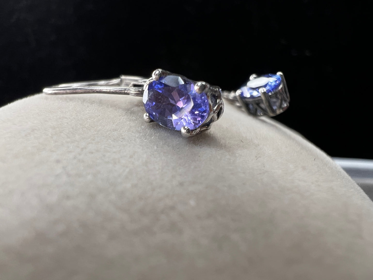 These sterling silver drop earrings feature a delicate tanzanite gemstone, adding a subtle splash of color and graceful movement to your look. Ideal for everyday wear or special occasions.