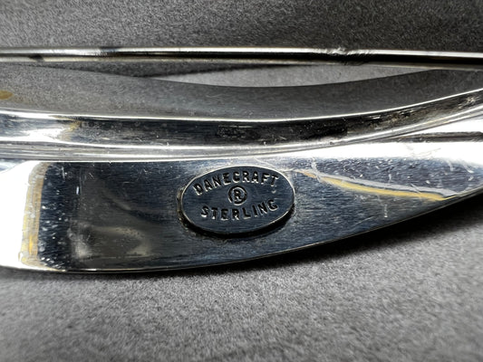 This Danecraft sterling silver brooch features an elegant leaf design measuring just over 4 inches, making it a standout accessory.