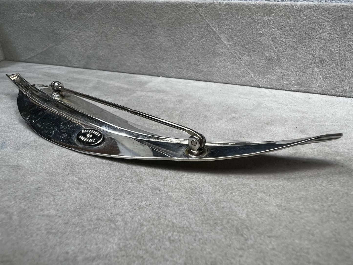 This Danecraft sterling silver brooch features an elegant leaf design measuring just over 4 inches, making it a standout accessory.