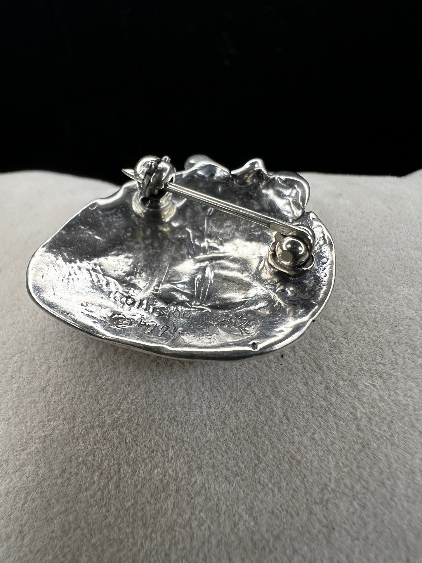 This sterling silver brooch, titled "Collision of Ideas," is expertly crafted to resemble a human heart. Its unique design combines artistic expression with fine craftsmanship.