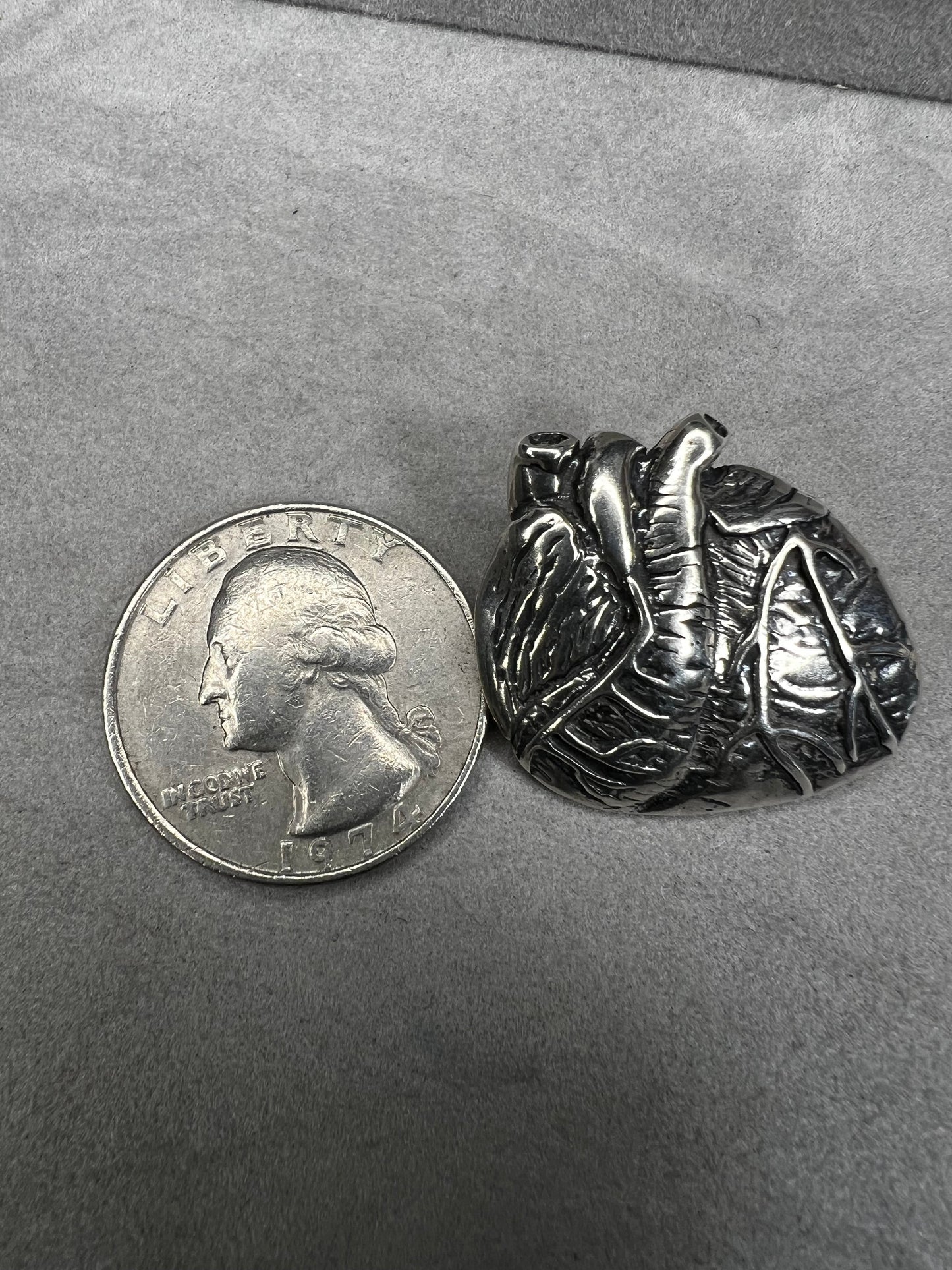 This sterling silver brooch, titled "Collision of Ideas," is expertly crafted to resemble a human heart. Its unique design combines artistic expression with fine craftsmanship.