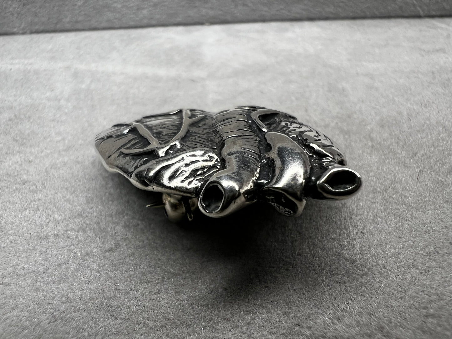 This sterling silver brooch, titled "Collision of Ideas," is expertly crafted to resemble a human heart. Its unique design combines artistic expression with fine craftsmanship.