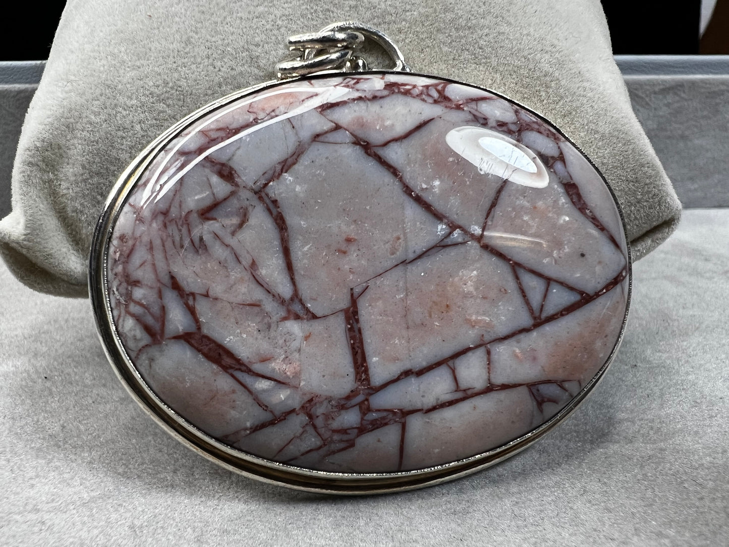 This large natural spiderweb jasper stone is beautifully set in a sterling silver frame, enhanced with a double jump ring for extra durability. Perfect for adding a touch of natural elegance to your everyday look.