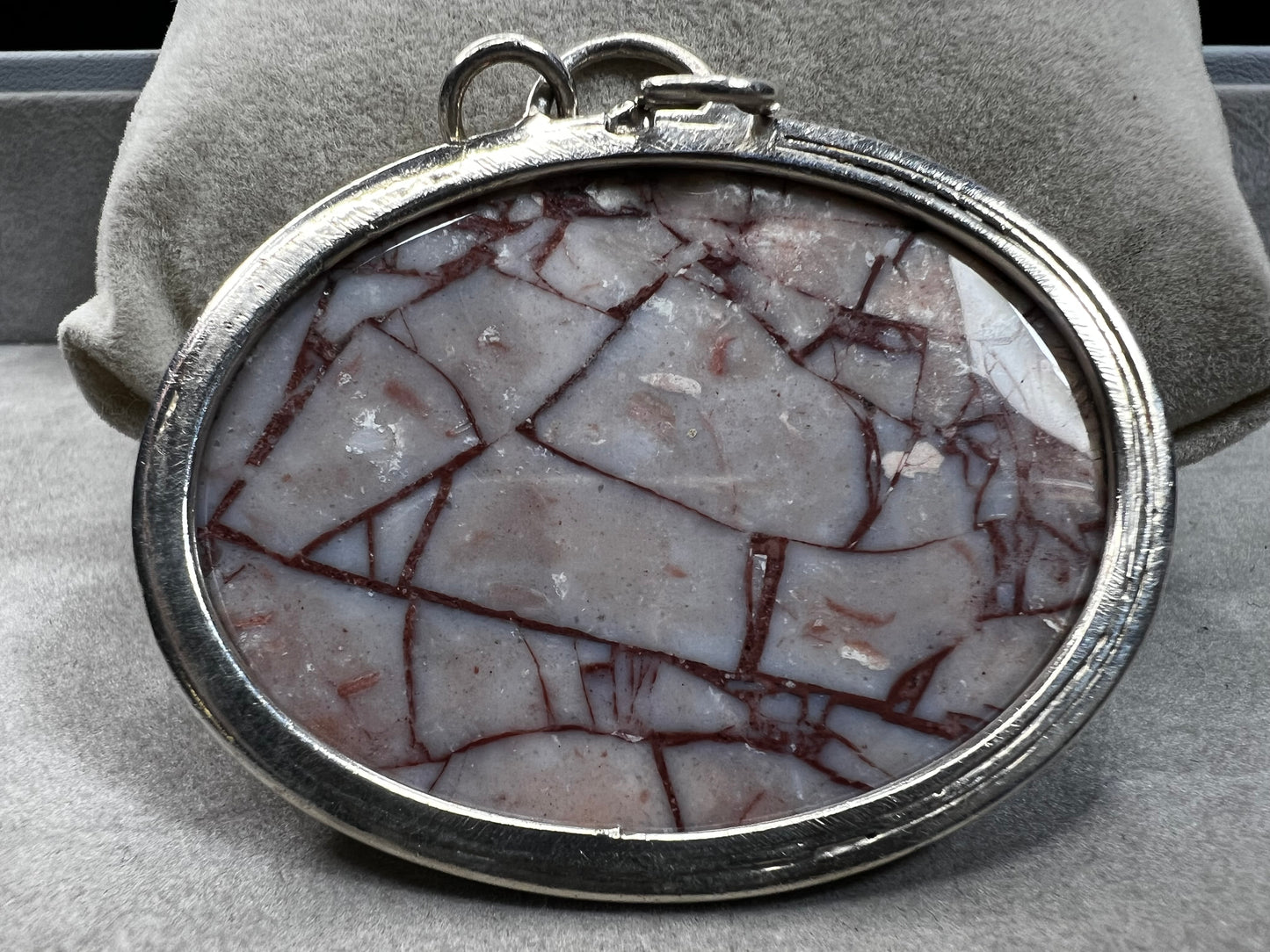 This large natural spiderweb jasper stone is beautifully set in a sterling silver frame, enhanced with a double jump ring for extra durability. Perfect for adding a touch of natural elegance to your everyday look.