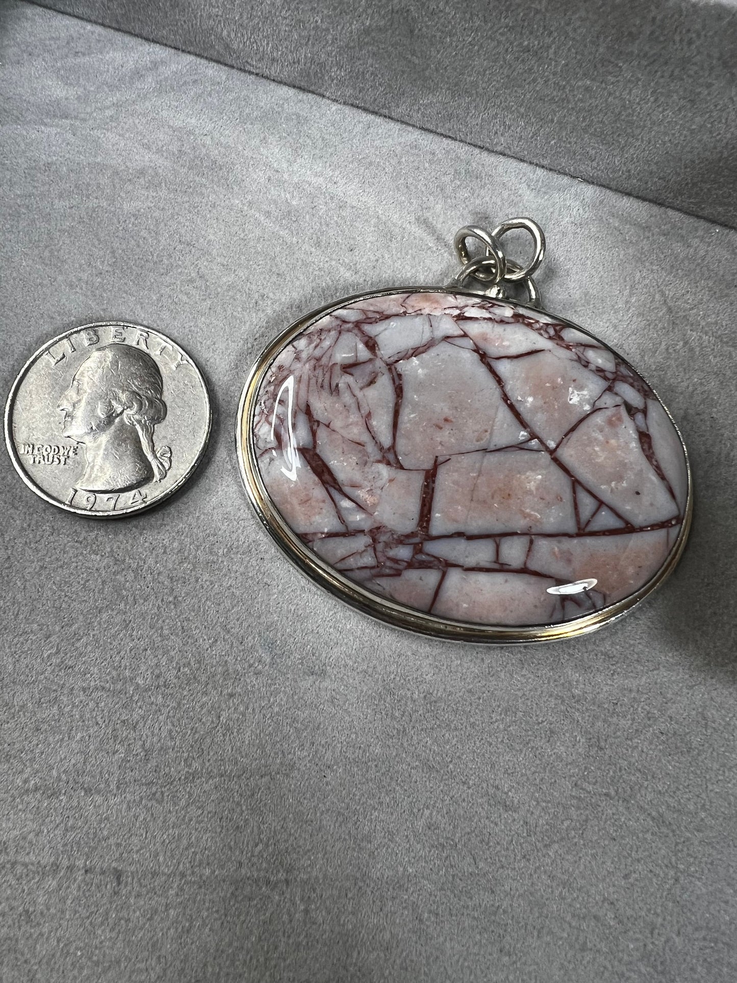 This large natural spiderweb jasper stone is beautifully set in a sterling silver frame, enhanced with a double jump ring for extra durability. Perfect for adding a touch of natural elegance to your everyday look.