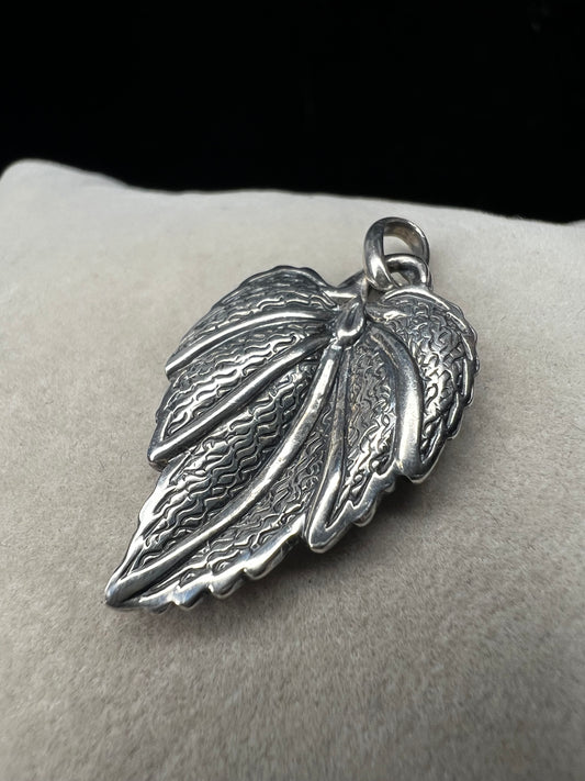 This 1-inch leaf crafted from sterling silver offers versatile wear as either a pendant or charm. Its elegant design brings a natural touch to your jewelry, making it a meaningful addition to any collection.