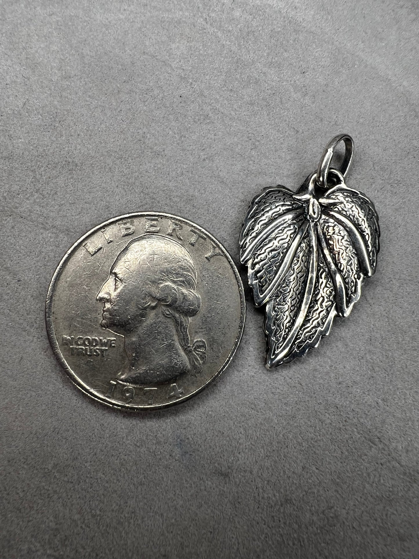 This 1-inch leaf crafted from sterling silver offers versatile wear as either a pendant or charm. Its elegant design brings a natural touch to your jewelry, making it a meaningful addition to any collection.