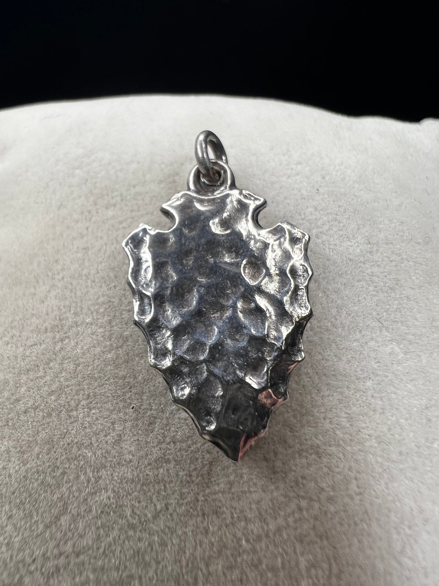 This sterling silver arrowhead, measuring 1 inch, offers versatile wear as either a charm or a pendant. Its sleek design adds a subtle touch of elegance, making it a meaningful accessory that complements any style with ease.