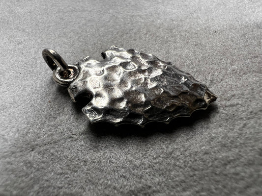 This sterling silver arrowhead, measuring 1 inch, offers versatile wear as either a charm or a pendant. Its sleek design adds a subtle touch of elegance, making it a meaningful accessory that complements any style with ease.