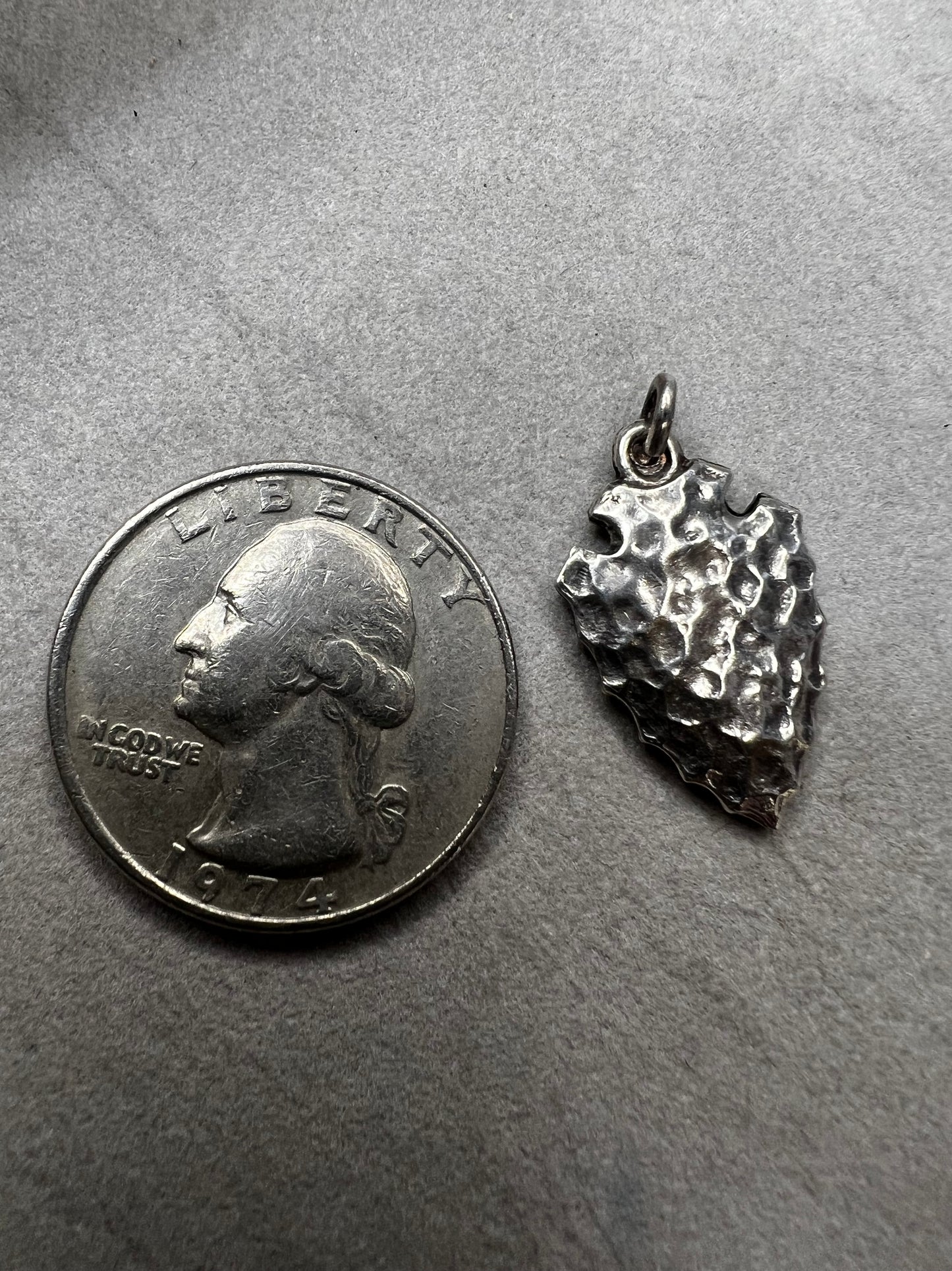 This sterling silver arrowhead, measuring 1 inch, offers versatile wear as either a charm or a pendant. Its sleek design adds a subtle touch of elegance, making it a meaningful accessory that complements any style with ease.