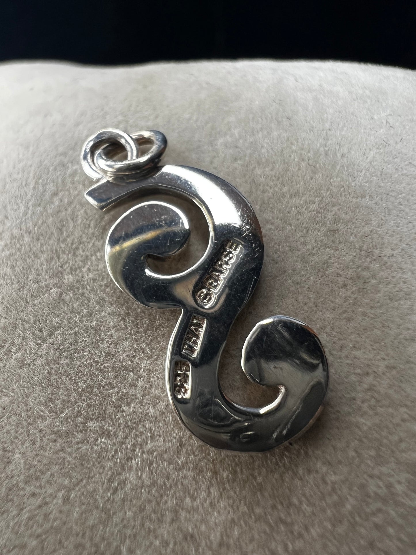 This sterling silver piece offers the flexibility to be worn as a charm or pendant, adapting effortlessly to your style. Signed Barse.