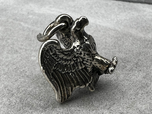 This eagle charm is expertly crafted from solid sterling silver. Its detailed design symbolizes strength and freedom, making it a perfect piece to celebrate your personal style and values.