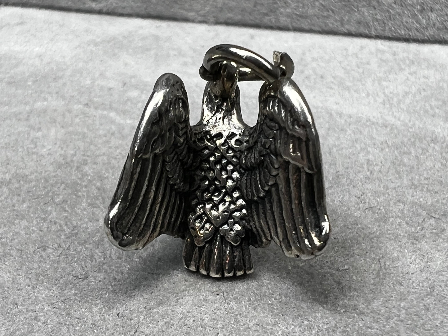This eagle charm is expertly crafted from solid sterling silver. Its detailed design symbolizes strength and freedom, making it a perfect piece to celebrate your personal style and values.
