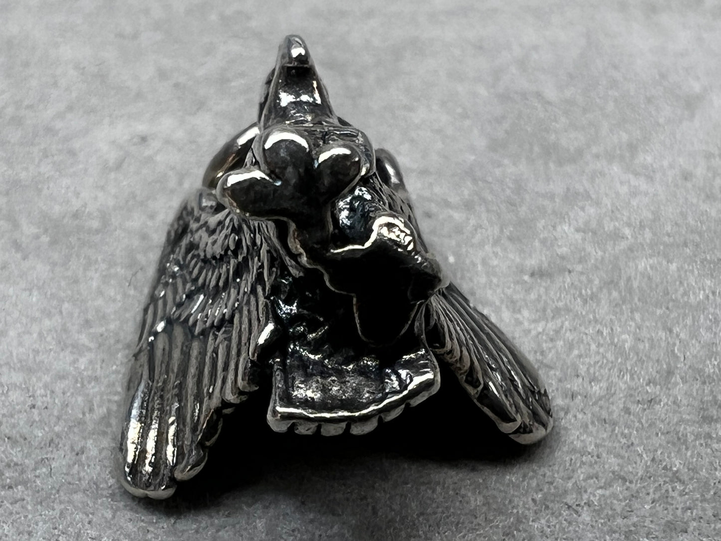 This eagle charm is expertly crafted from solid sterling silver. Its detailed design symbolizes strength and freedom, making it a perfect piece to celebrate your personal style and values.