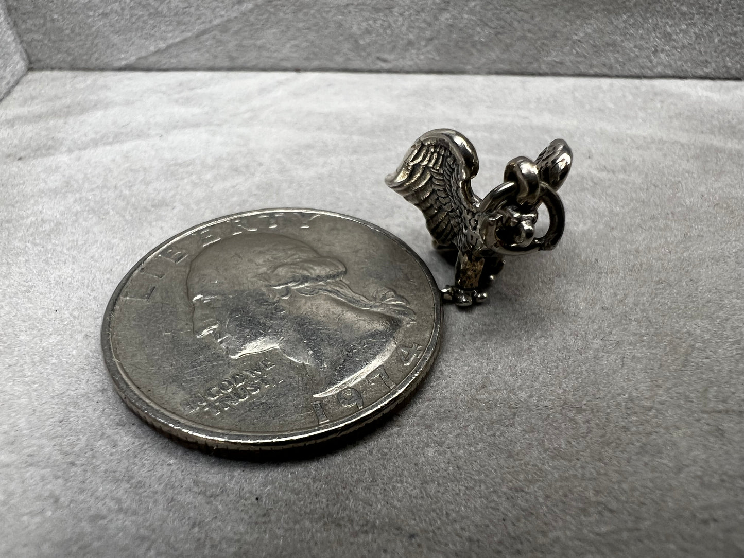This eagle charm is expertly crafted from solid sterling silver. Its detailed design symbolizes strength and freedom, making it a perfect piece to celebrate your personal style and values.