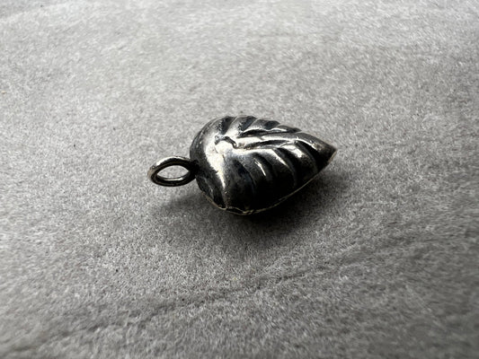 This sterling silver puffed leaf charm features delicate detailing on both sides, adding a subtle touch of nature-inspired elegance to your jewelry. Designed to be attached easily with a jump ring, it’s perfect for customizing your bracelet or necklace with a meaningful accent.