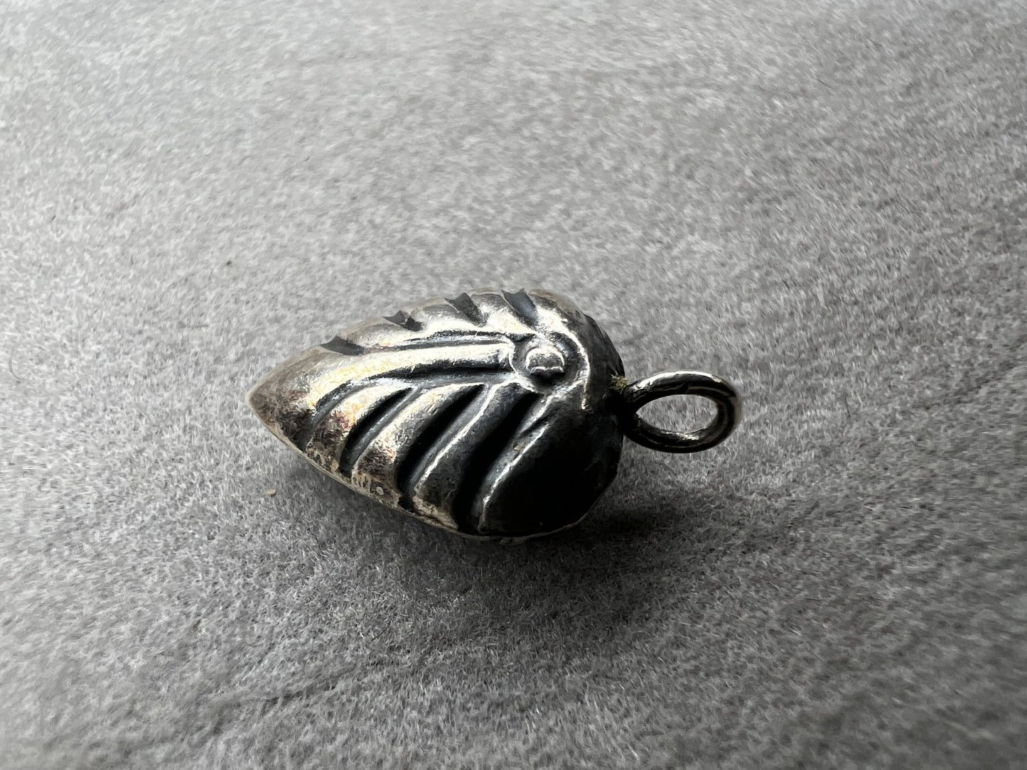 This sterling silver puffed leaf charm features delicate detailing on both sides, adding a subtle touch of nature-inspired elegance to your jewelry. Designed to be attached easily with a jump ring, it’s perfect for customizing your bracelet or necklace with a meaningful accent.