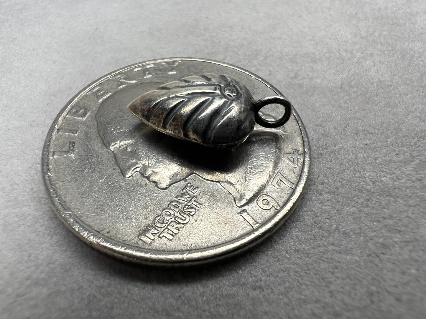 This sterling silver puffed leaf charm features delicate detailing on both sides, adding a subtle touch of nature-inspired elegance to your jewelry. Designed to be attached easily with a jump ring, it’s perfect for customizing your bracelet or necklace with a meaningful accent.