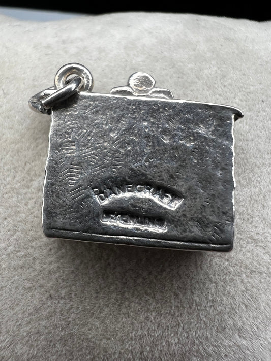 This Danecraft sterling silver charm captures the cozy holiday spirit with stockings hanging from the mantle above a wood-burning fire. It’s a charming addition to your Christmas collection, perfect for celebrating festive traditions and adding warmth to your jewelry.