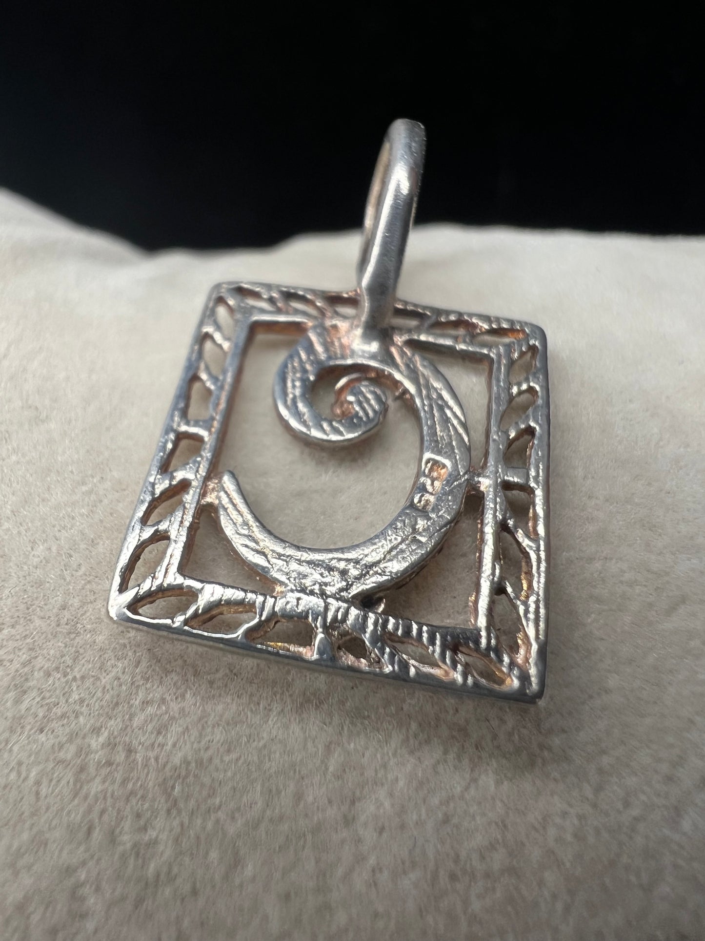 This sterling silver pendant features an elegant open work design with delicate diamond cuts, adding a refined touch to the classic "C" initial.