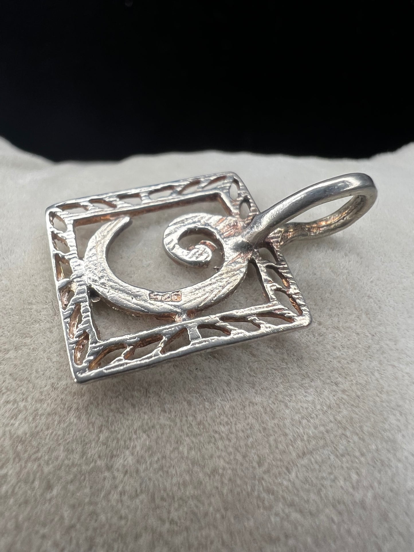 This sterling silver pendant features an elegant open work design with delicate diamond cuts, adding a refined touch to the classic "C" initial.