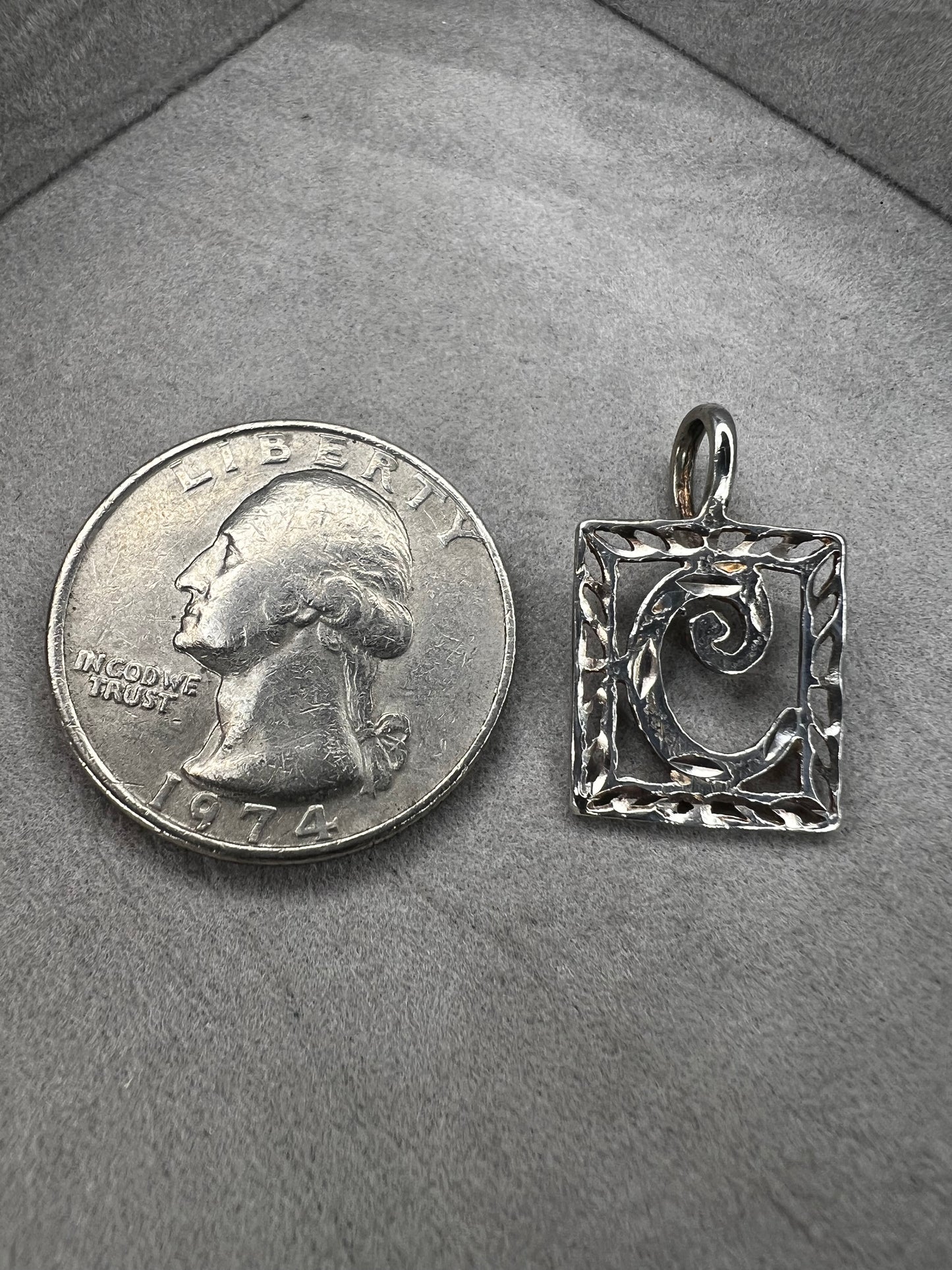 This sterling silver pendant features an elegant open work design with delicate diamond cuts, adding a refined touch to the classic "C" initial.