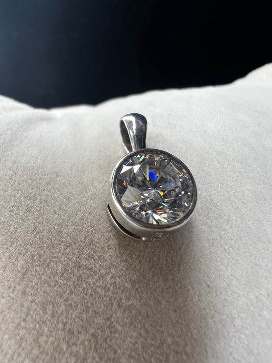 This petite pendant showcases a tourmaline set in sterling silver, offering a subtle yet elegant touch of class. Its delicate size makes it perfect for layering or wearing alone, and it pairs well with our small sterling chains.