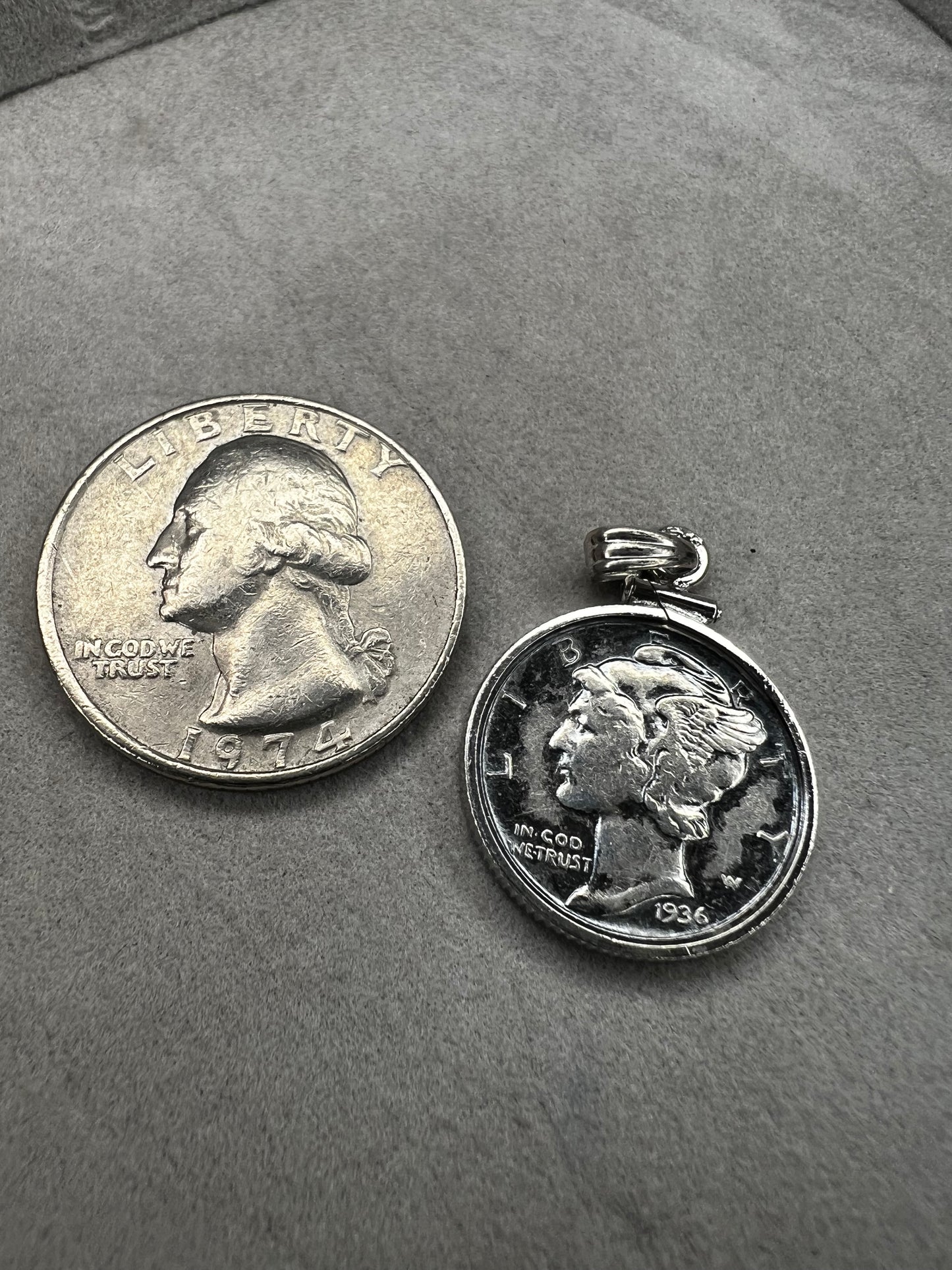 This pendant features a genuine 1936 silver Liberty Head dime, elegantly framed in sterling silver with a matching bail. It is a timeless accessory that combines historical charm with refined craftsmanship.