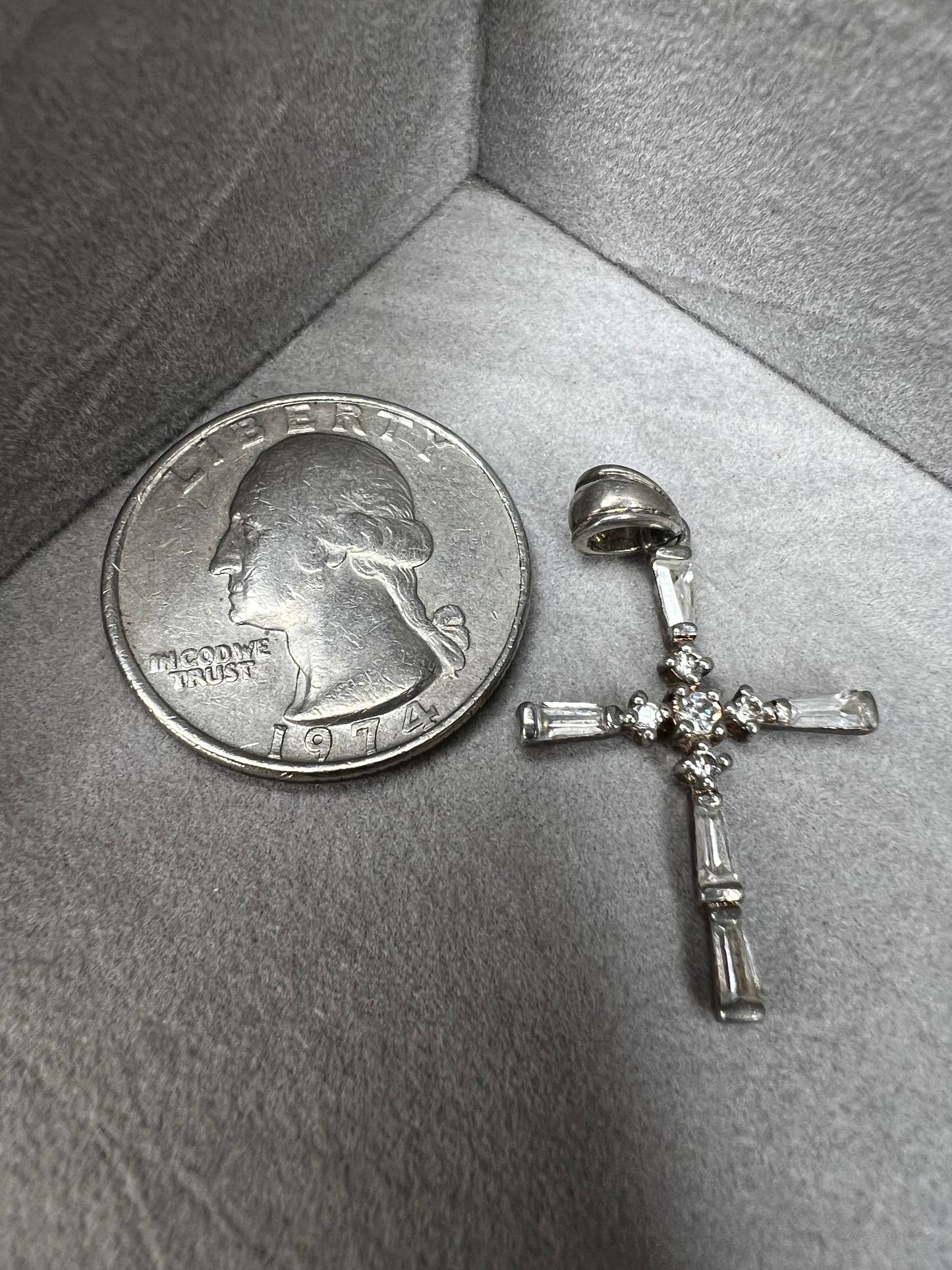 This vintage 1 1/4" sterling silver cross pendant features sparkling rhinestones that enhance its classic design.