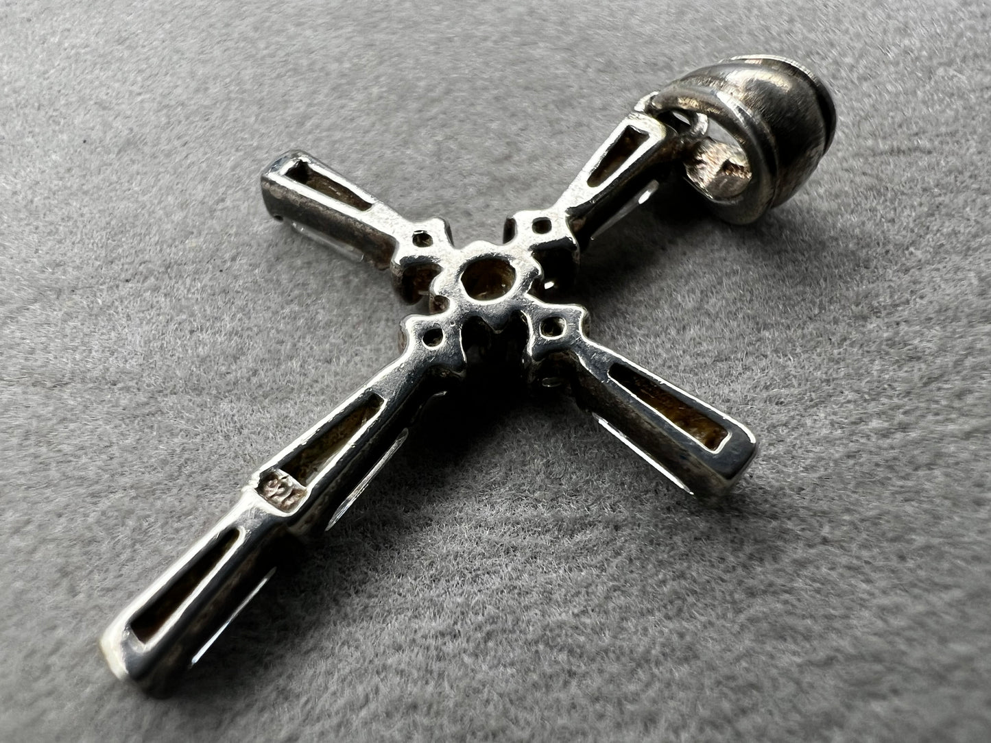 This vintage 1 1/4" sterling silver cross pendant features sparkling rhinestones that enhance its classic design.