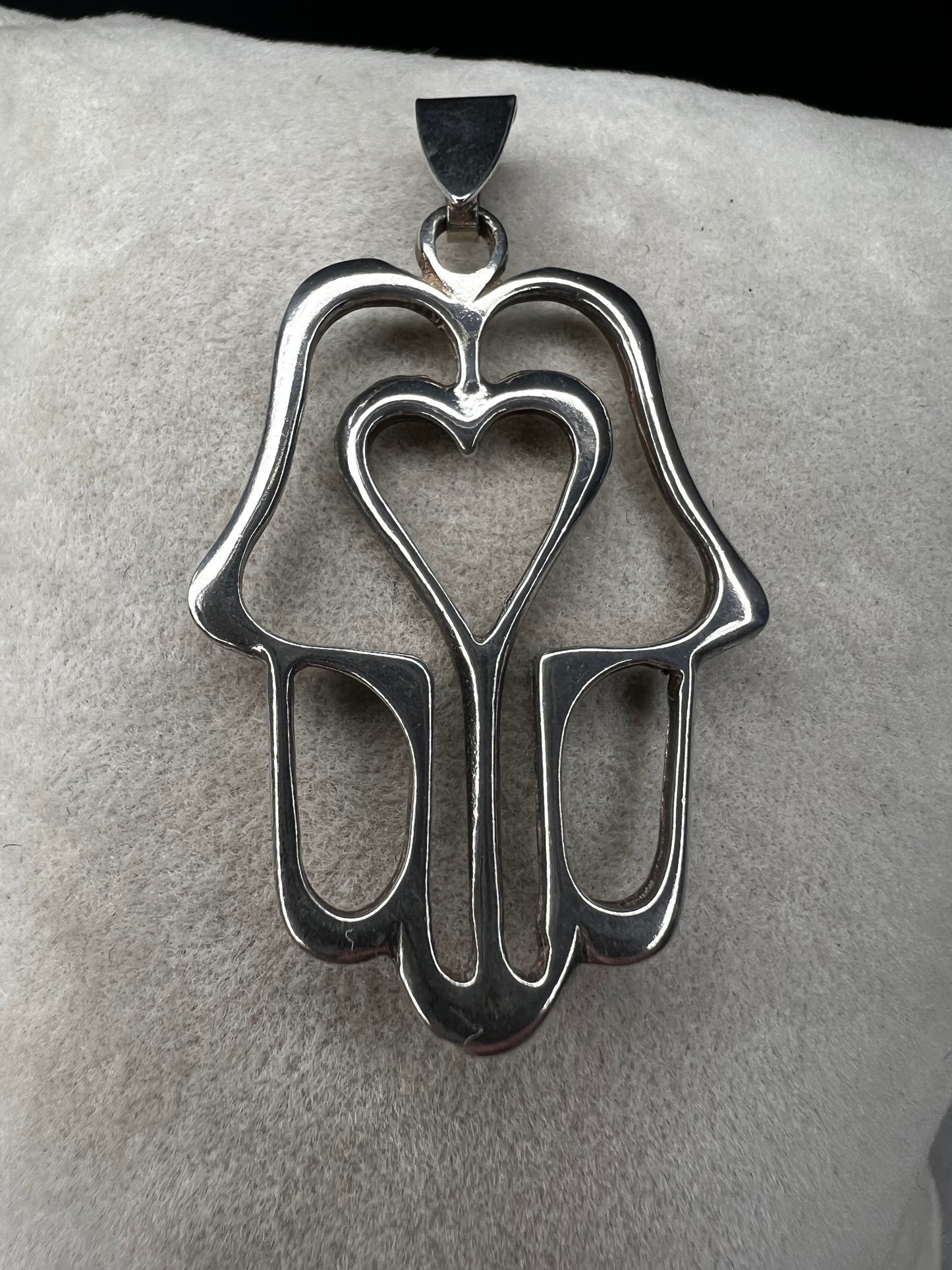 Crafted from sterling silver, this pendant is designed as a hamza hand, which is recognized by parts of the world as a symbol of protection. Made in Israel.