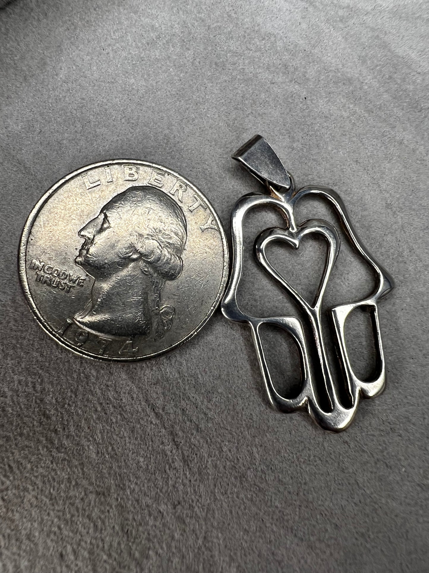 Crafted from sterling silver, this pendant is designed as a hamza hand, which is recognized by parts of the world as a symbol of protection. Made in Israel.