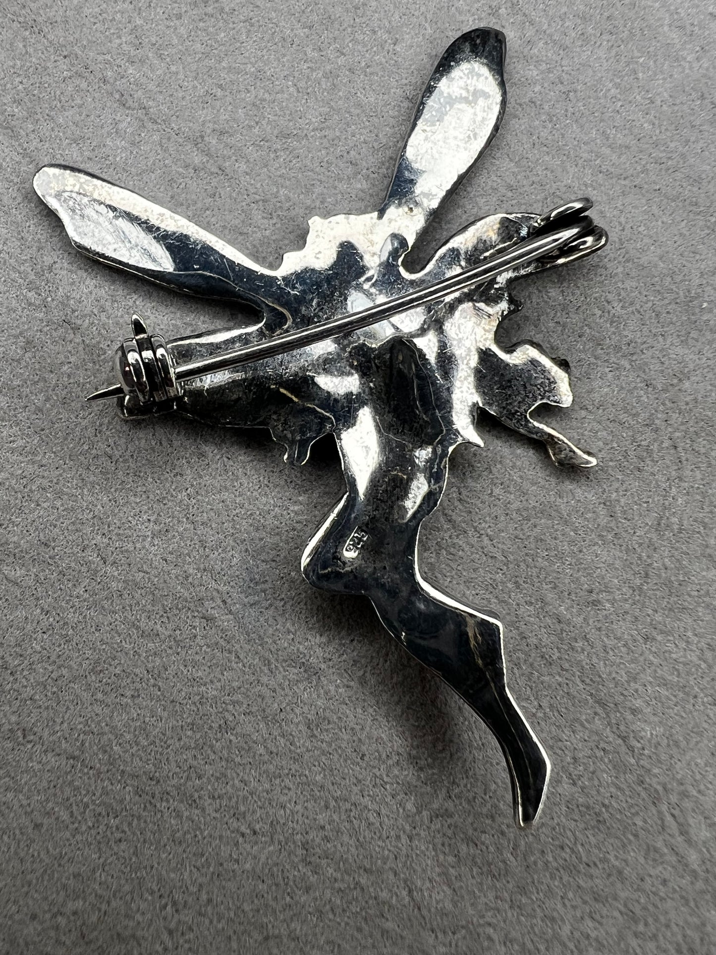 Crafted from sterling silver, this 2" nude goddess fairy brooch from the 1980s adds a unique touch to the right outfit or special occasion.