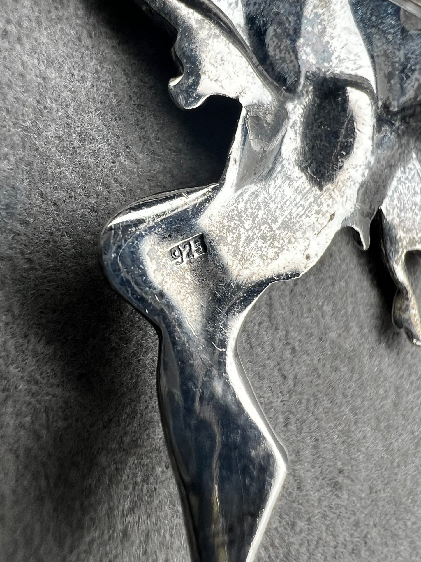 Crafted from sterling silver, this 2" nude goddess fairy brooch from the 1980s adds a unique touch to the right outfit or special occasion.