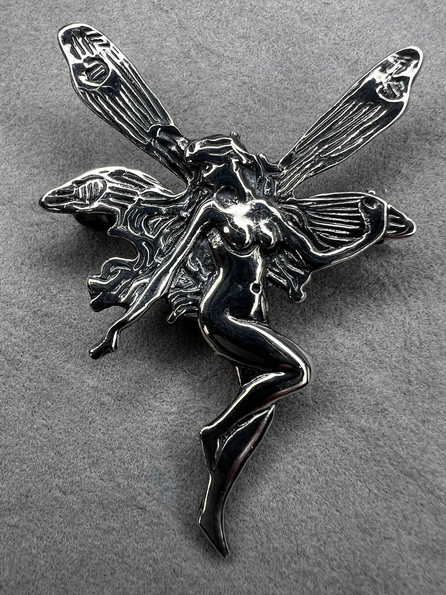 Crafted from sterling silver, this 2" nude goddess fairy brooch from the 1980s adds a unique touch to the right outfit or special occasion.