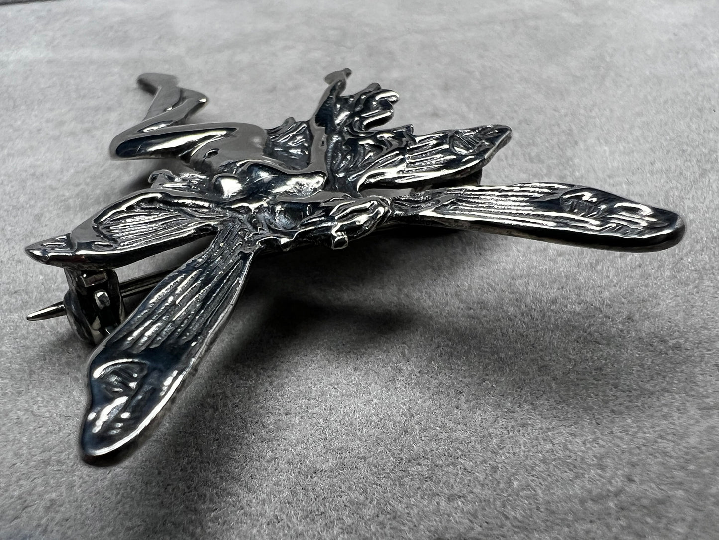 Crafted from sterling silver, this 2" nude goddess fairy brooch from the 1980s adds a unique touch to the right outfit or special occasion.