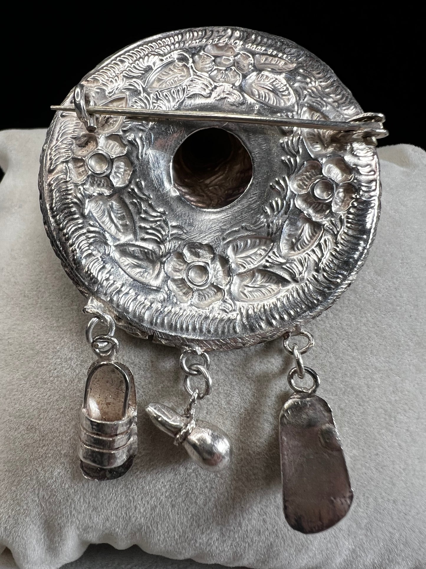 This charming 1950s sterling silver brooch captures a playful scene with a large sombrero, a pair of sandals, and a maraca. Its unique design reflects vintage character and cultural flair, making it a delightful accessory that adds personality and nostalgia to your collection.